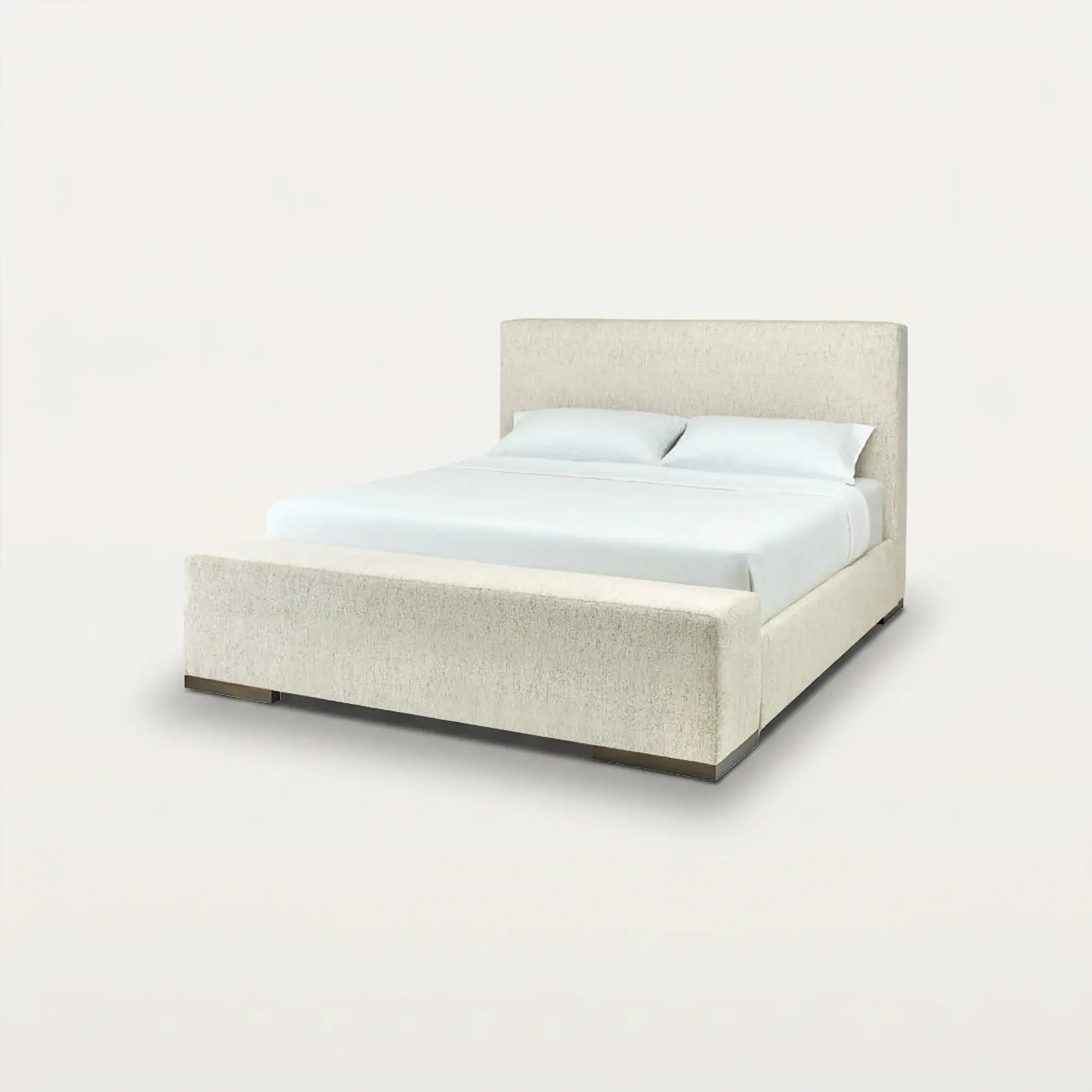A light beige upholstered bed with a tall headboard, white bedding, and a matching footboard bench, set against a plain light background.