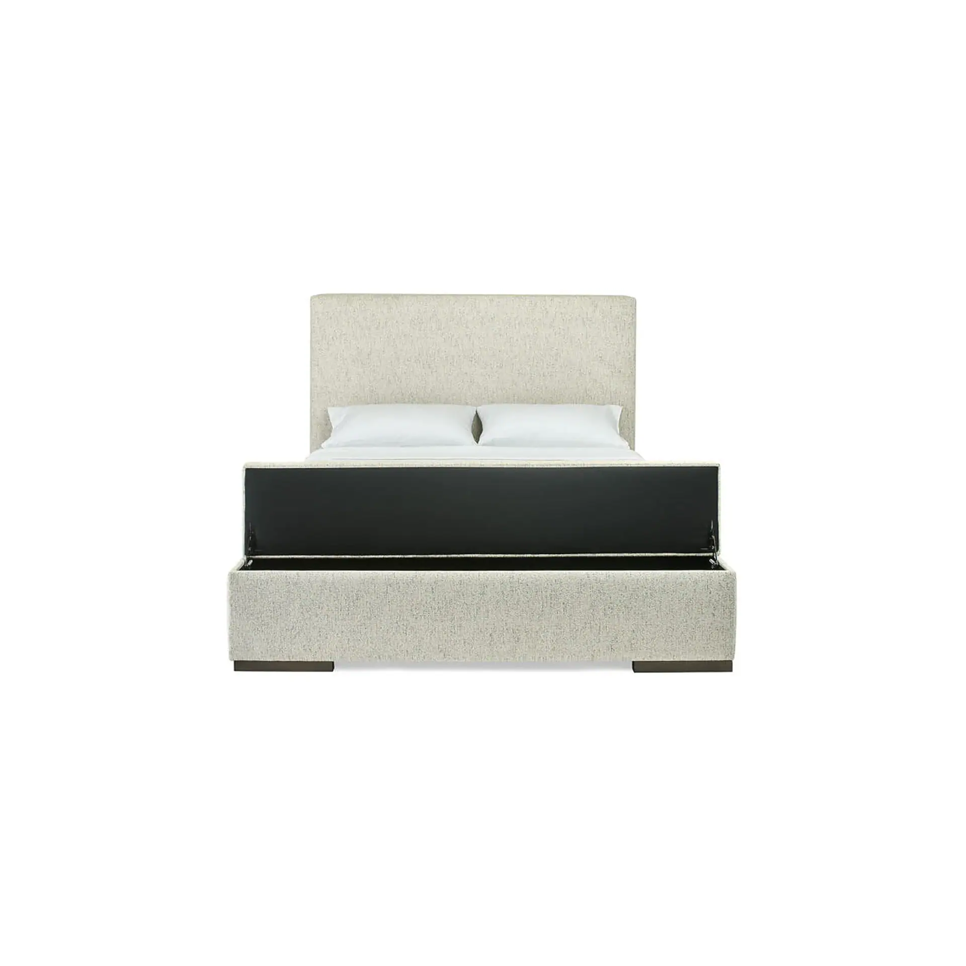 Light beige upholstered bed with a tall headboard and the foot end lifted to reveal a spacious under-bed storage compartment. A mattress with white sheets and two pillows is visible.