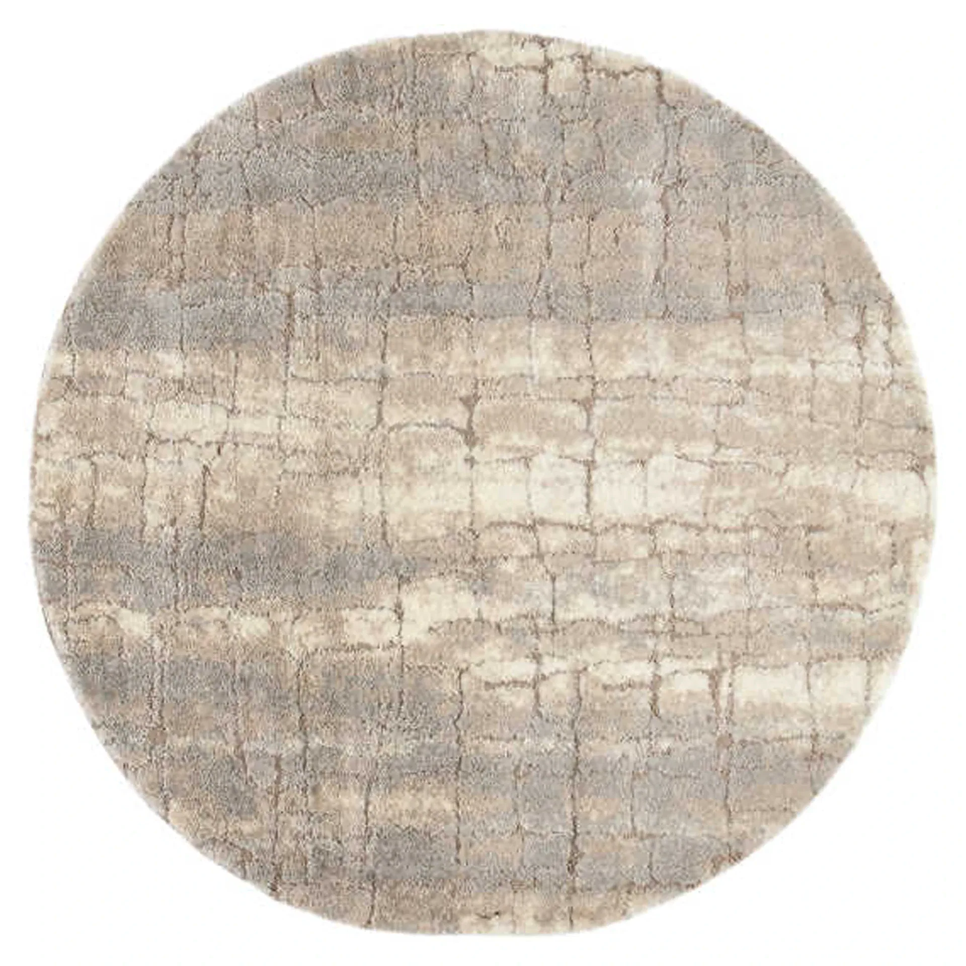 A round, plush area rug with an abstract, distressed pattern in shades of beige, light brown, and off-white.