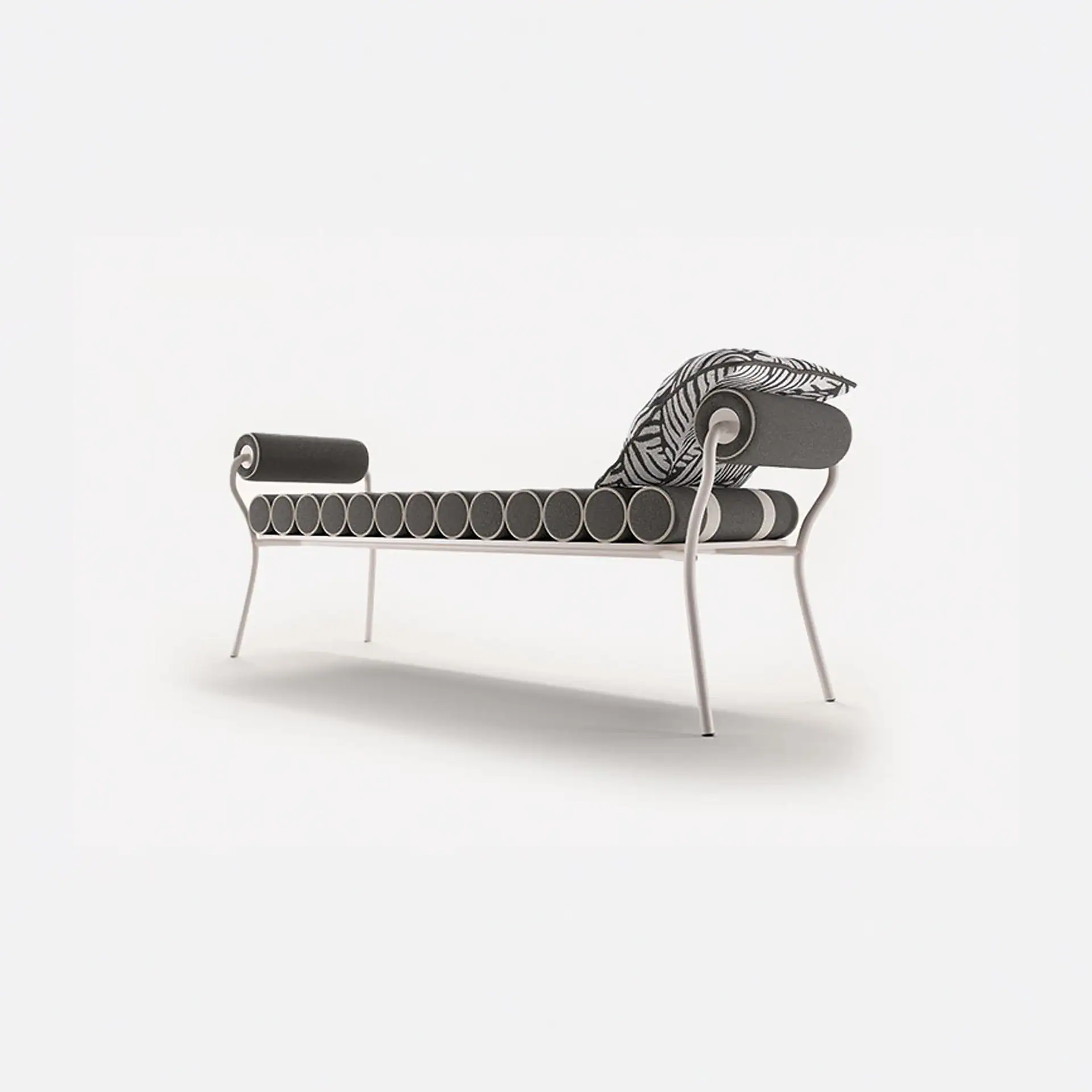 A modern chaise lounge with a light metal frame, dark grey cylindrical cushions, and a black and white patterned pillow on a white background.