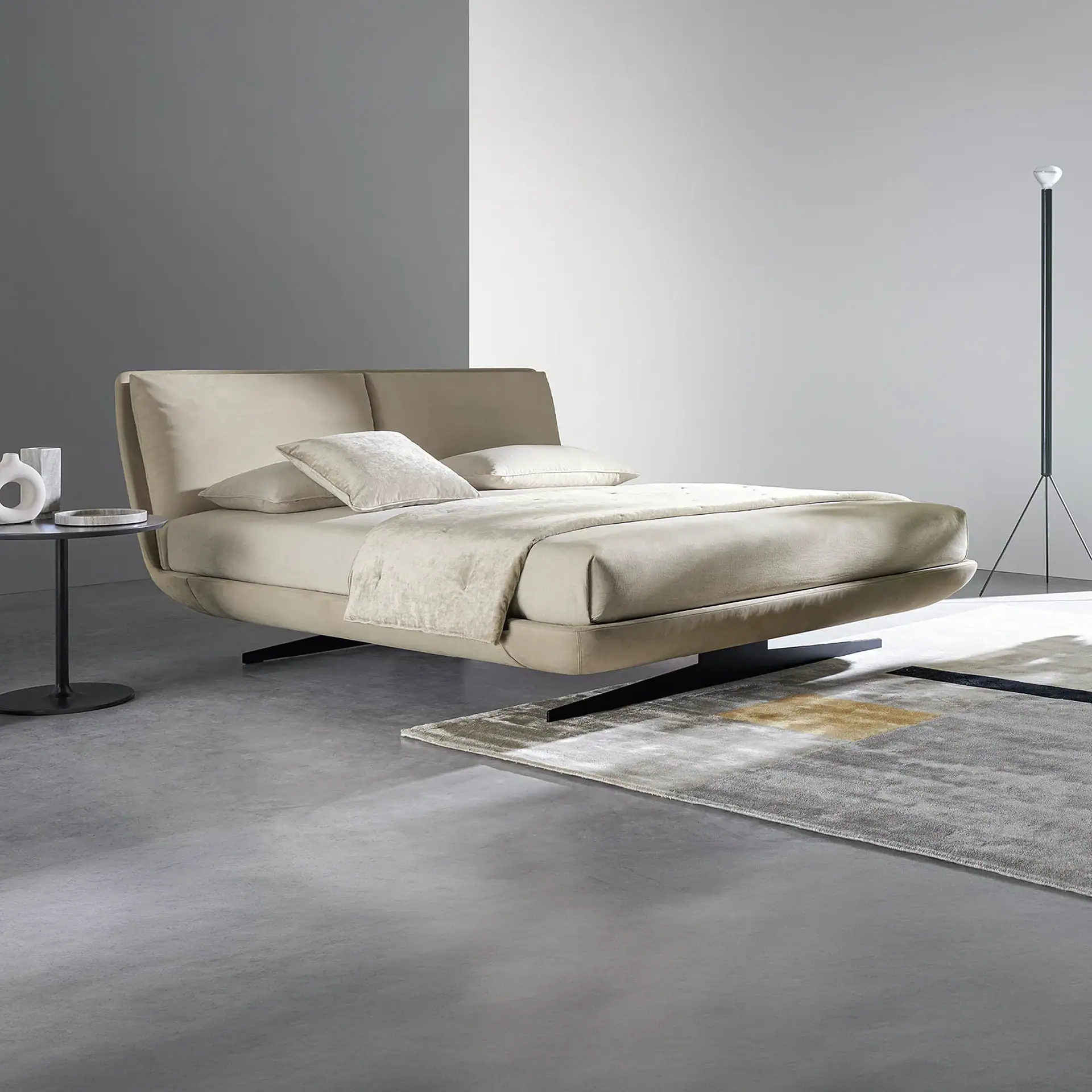Sklar upholstered bed in beige with matching bedding in a modern bedroom.