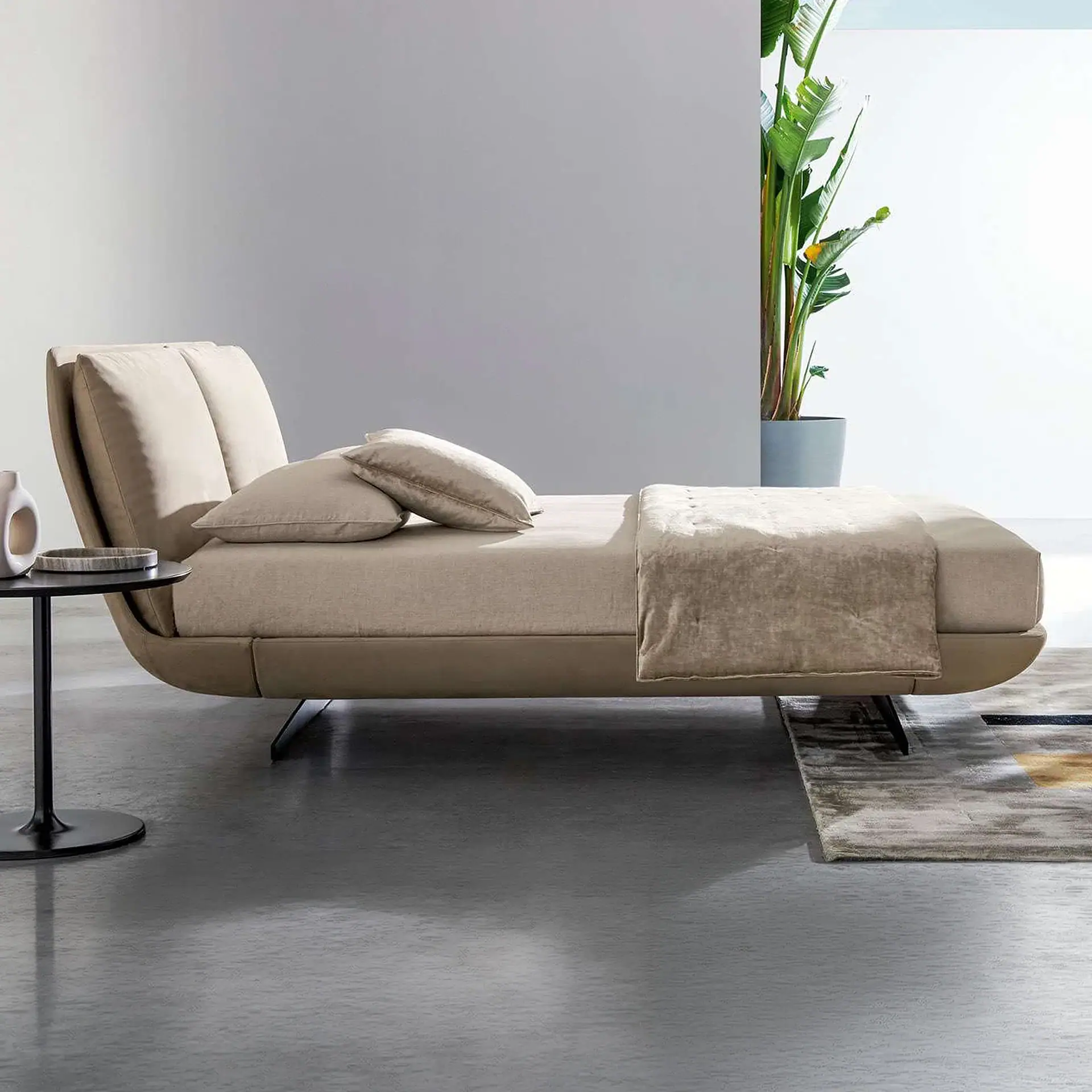 Sklar Upholstered Bed with beige fabric and low-profile frame in a modern showroom.