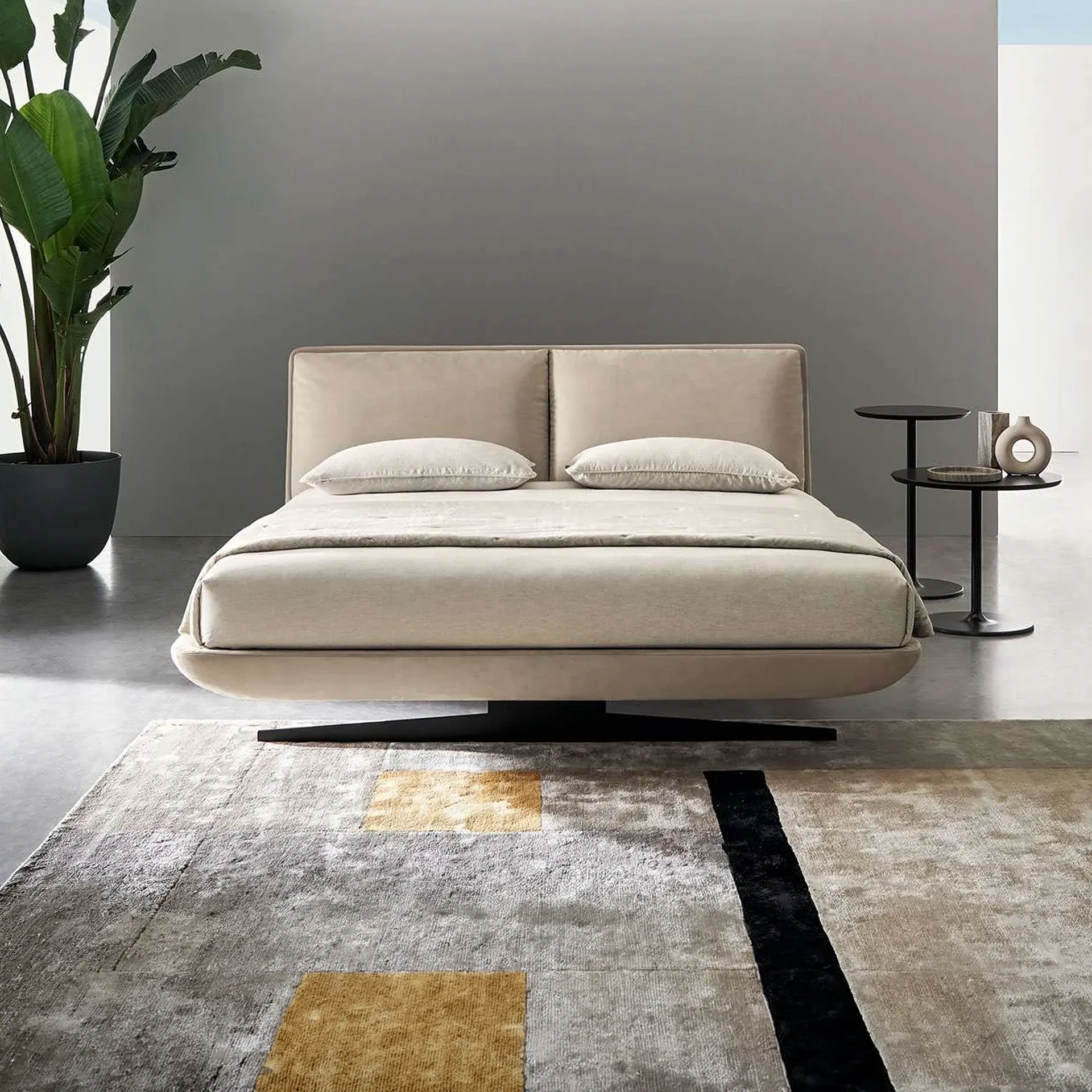 Sklar Furnishings beige upholstered bed with a low-profile headboard in a modern bedroom.